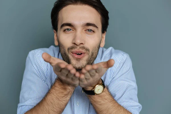 Joyful handsome man sending air kisses — Stock Photo, Image