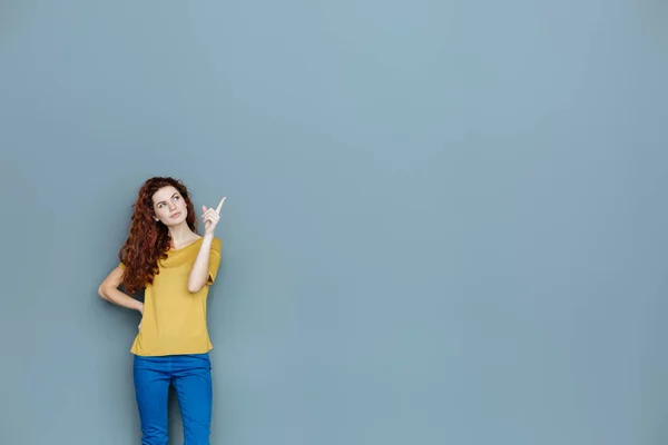 Mujer agradable inteligente señalando con su dedo —  Fotos de Stock