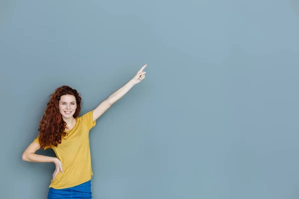 Happy delighted woman pointing with her hand — Stock Photo, Image