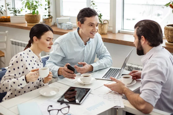 Inspired colleagues drinking some coffee and talking — Stock Photo, Image