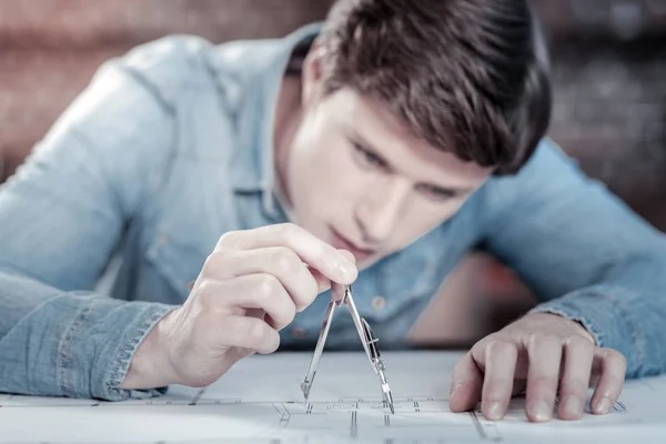 Charming male engineer measuring distance — Stock Photo, Image