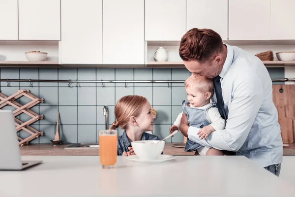 Delighted male embracing his baby — Stock Photo, Image