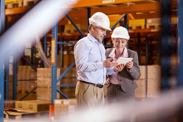 Cheerful positive woman looking at the tablet screen — Stock Photo, Image