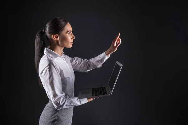 Smart intelligent businesswoman looking at her hand