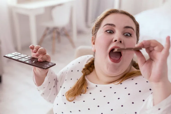 Chubby red-head woman going crazy about chocolate — Stock Photo, Image