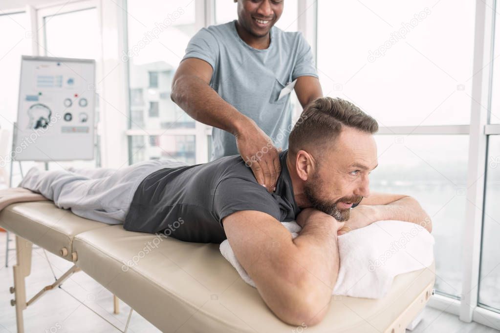 Joyful bearded man enjoying the procedure