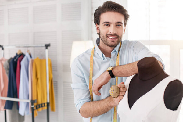 Concentrated dressmaker working on a new dress