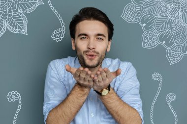 Yakışıklı genç adamın hava öpücük göndermesini yakın çekim