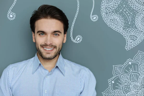 Close up of attractive young man with pleasant smile — Stock Photo, Image