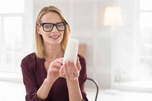 Musing female designer examining sample — Stock Photo, Image