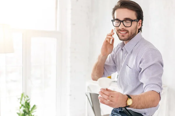 Glad businessman talking on the phone