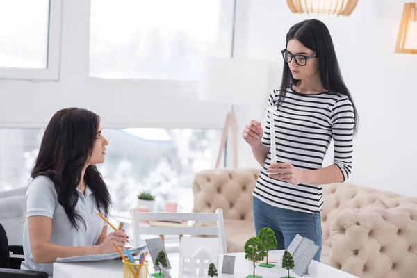 Innovative View Pleasant Colleague Standing Crippled Woman Writing — Stock Photo, Image