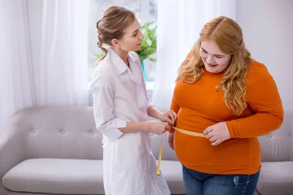 Beslutsamma läkare talar med en fyllig kvinna — Stockfoto