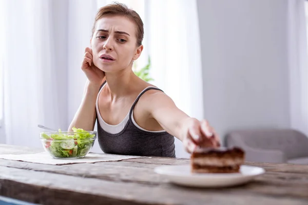 郁闷的年轻女人想要一个蛋糕 — 图库照片