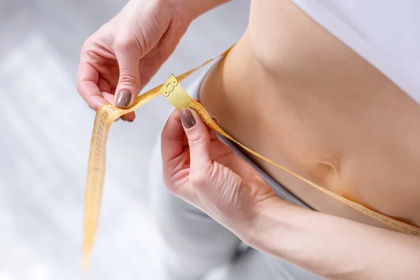 Close up of a centimeter tape around the waist — Stock Photo, Image