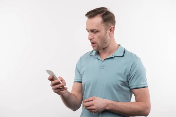 Pleasant nice man looking at his gadget — Stock Photo, Image