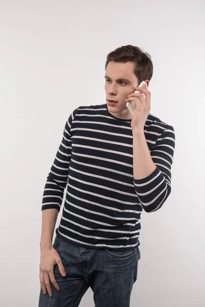 Handsome young man talking on the phone