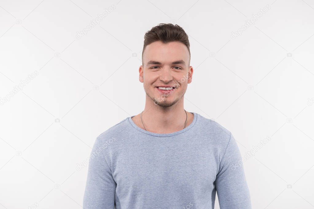 Joyful young man being in a good mood
