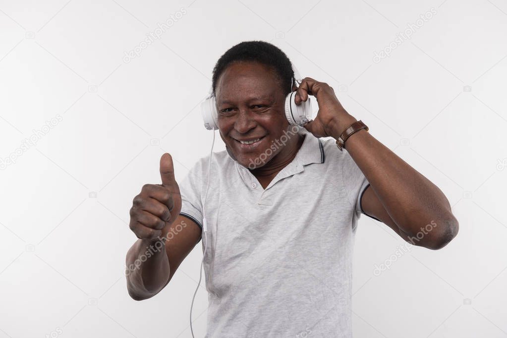 Joyful happy man showing OK gesture