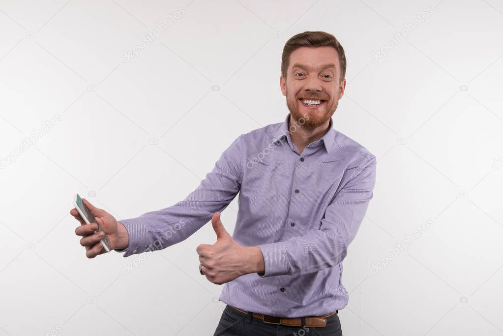 Cheerful young man showing OK sign