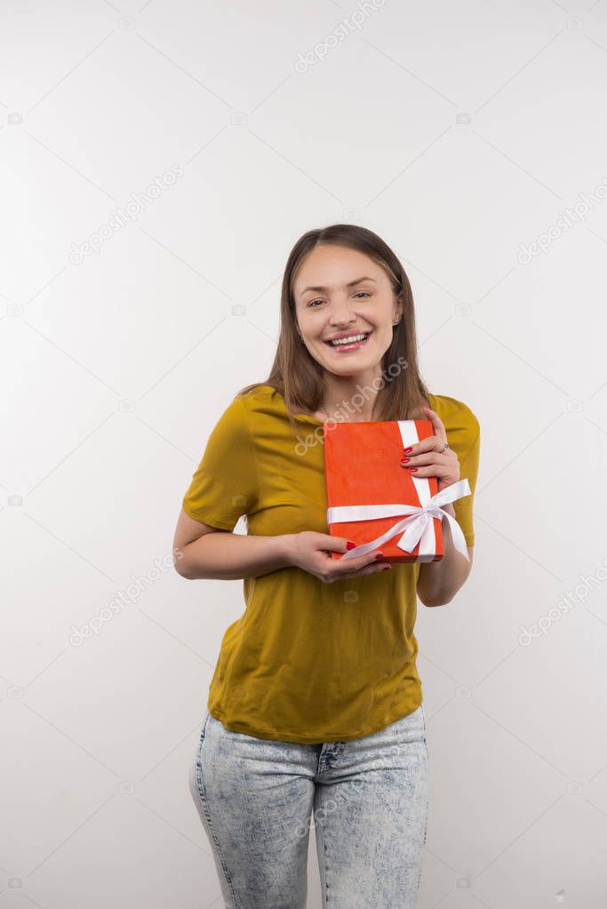 Pleasant attractive woman showing her present
