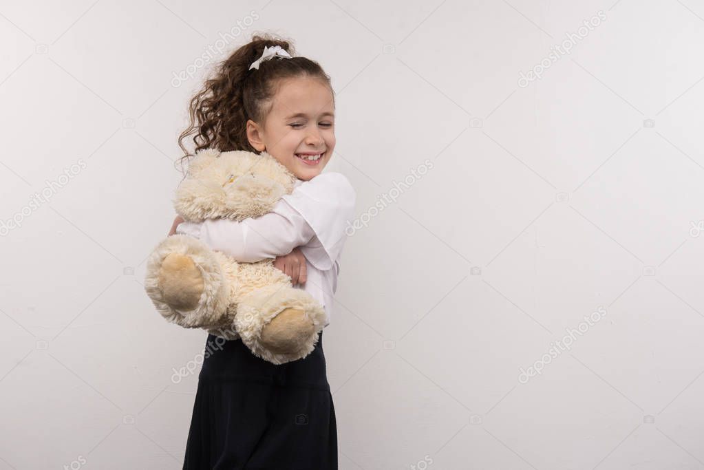 Happy young girl hugging her toy