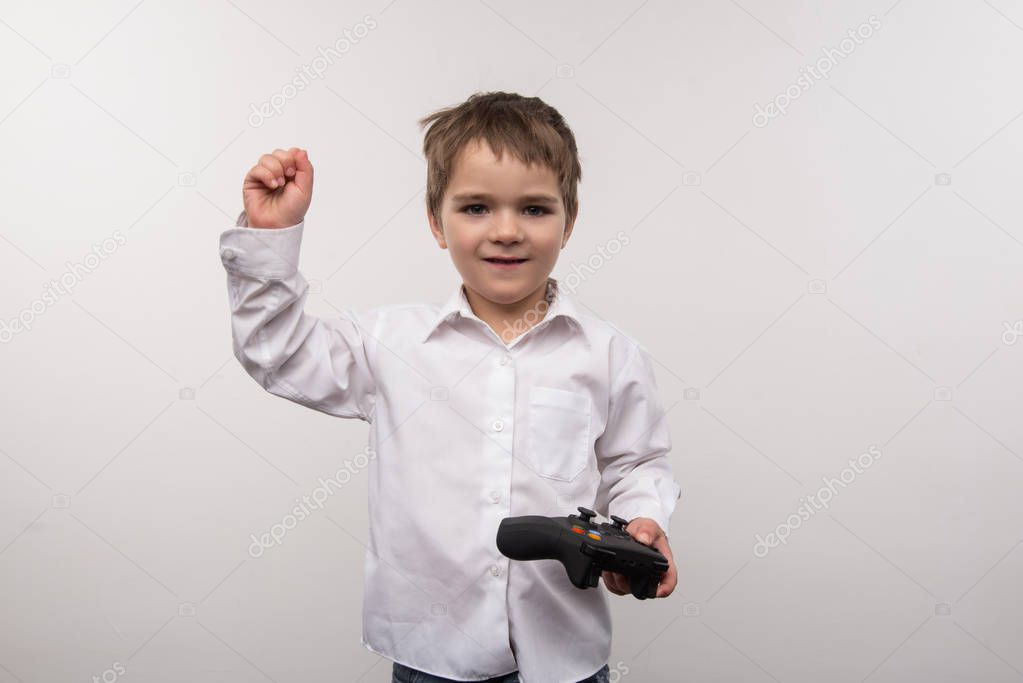 Nice cute boy playing electronic games