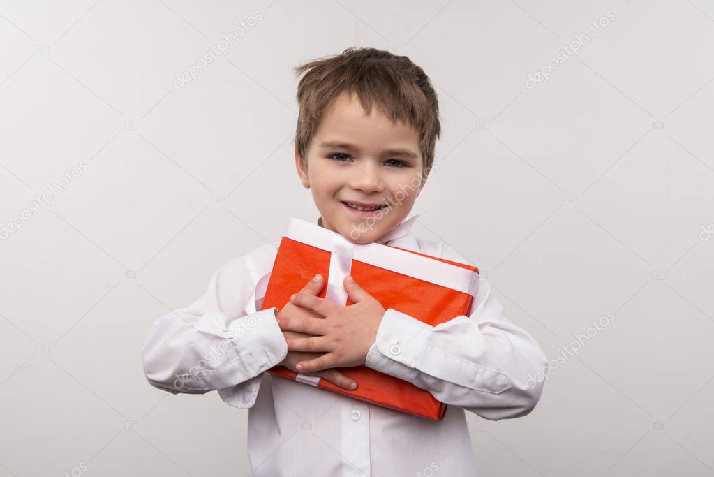 Cute small boy hugging a present