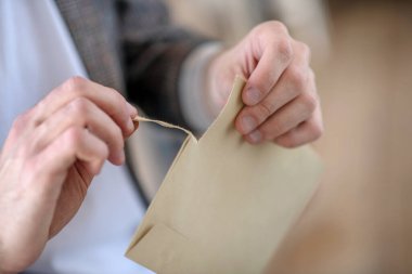 Man opening his post mail after receiving letter clipart