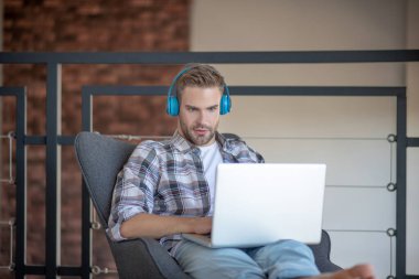 Hafta sonu iş adamı dizüstü bilgisayardan film izliyor.