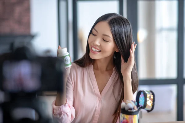 Beauty blogger feeling satisfied after taking hair growth vitamins — Stock Photo, Image