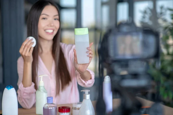 Close up of beauty blogger recommending micellar water — Stock Photo, Image