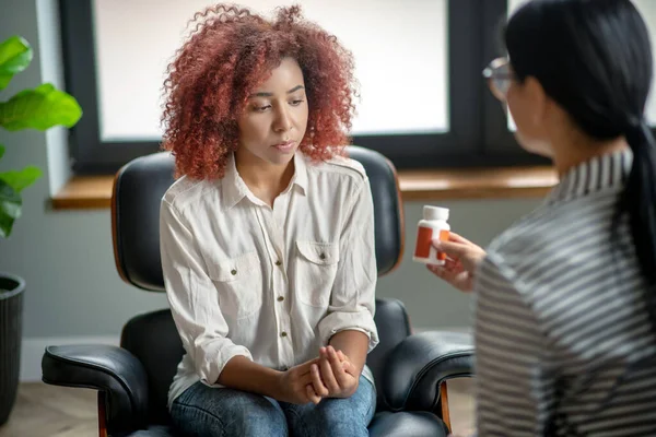 Curly young woman suffering from emotional disorder — Stock Photo, Image