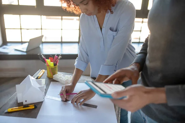 Assistent die schetsen maakt terwijl hij bij interieurontwerper staat — Stockfoto