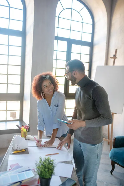 Couple enjoying work together while making sketches