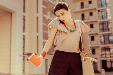 Duygusal iş kadını eşiyle telefonda konuşuyor.