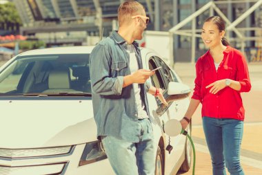 Neşeli Asyalı kadın genç adamla iletişim kuruyor.