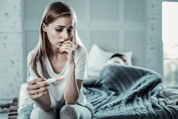 Mujer joven deprimida mirando los resultados de la prueba de embarazo — Foto de Stock