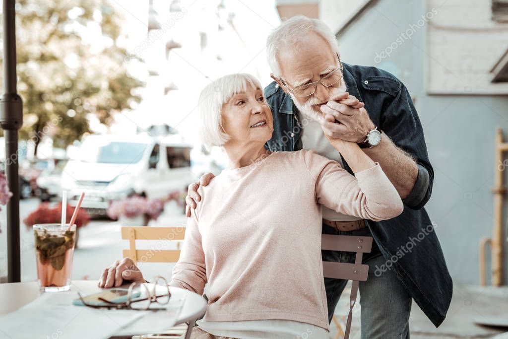 Nice aged man kissing his wifes hand