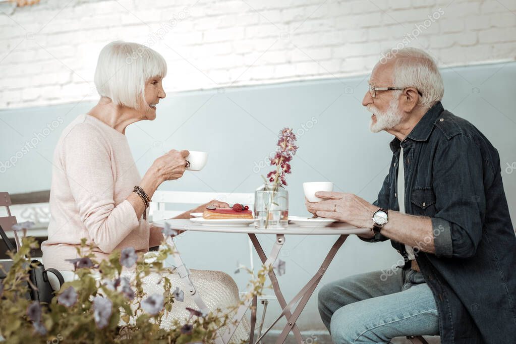 Positive nice aged people drinking coffee together