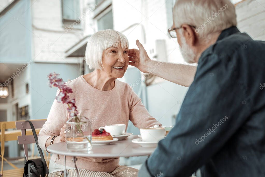 Nice joyful woman feeling the love of her husband