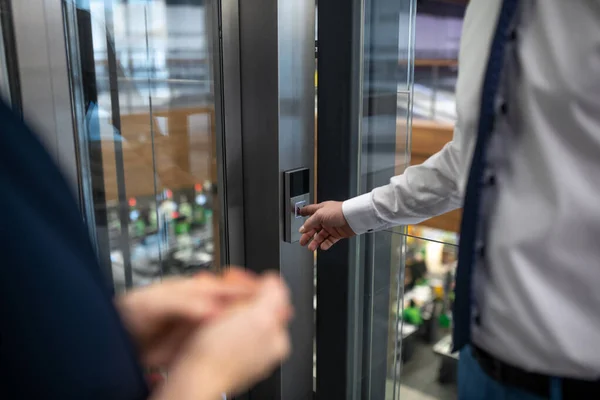 Zavřít obchodníka stisknutím tlačítka při čekání na výtah — Stock fotografie