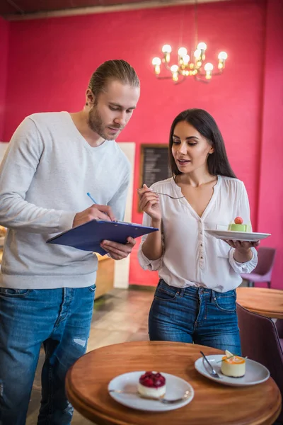 Businessmen discussing desserts together before launching new menu — Stock Photo, Image