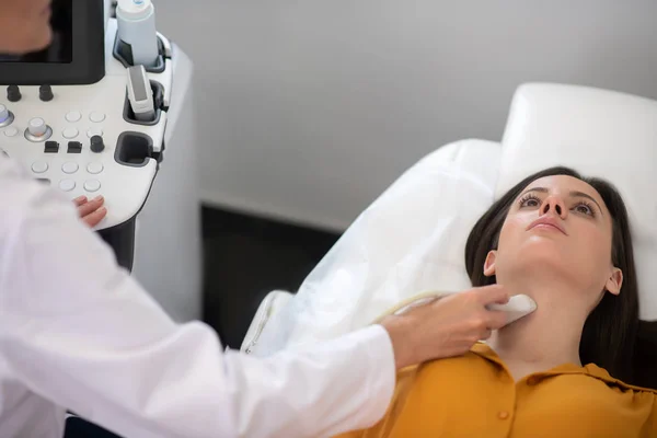 Médica feminina fazendo ultra-som teste da glândula tireóide — Fotografia de Stock