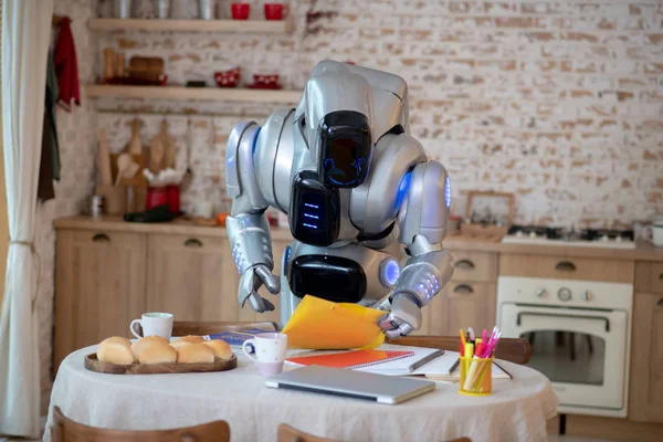 Robot standing near the table in the kitchen