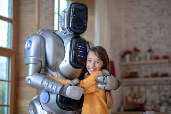 Picture of cute girl and big robot in the kitchen