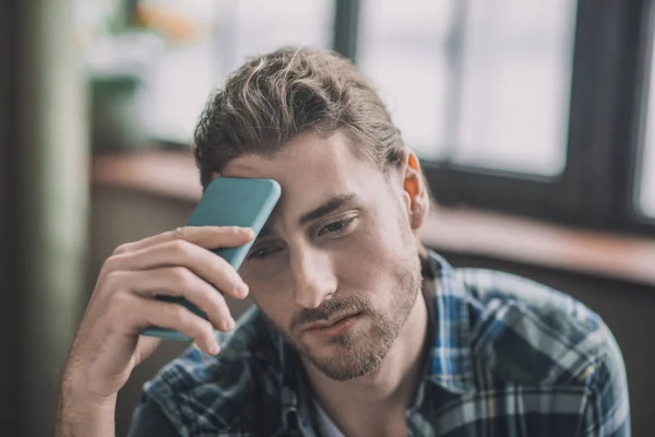 Hombres cansados y frustrados sosteniendo su teléfono móvil —  Fotos de Stock