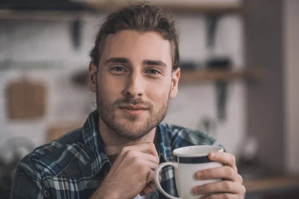 Handsome man having a cup of hot coffee — Stock Photo, Image