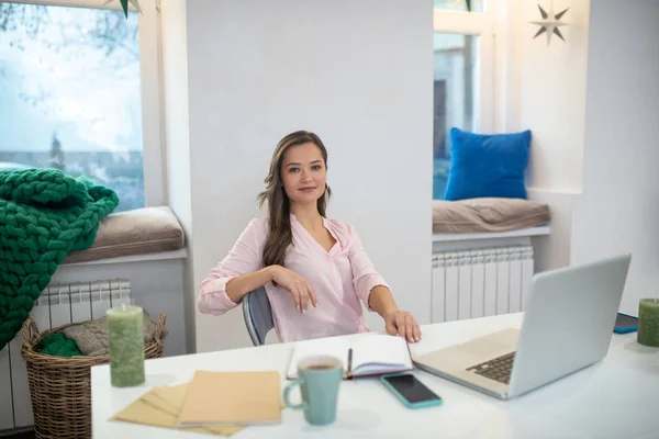 Positive happy businesswoman sitting in her office — Stock Photo, Image