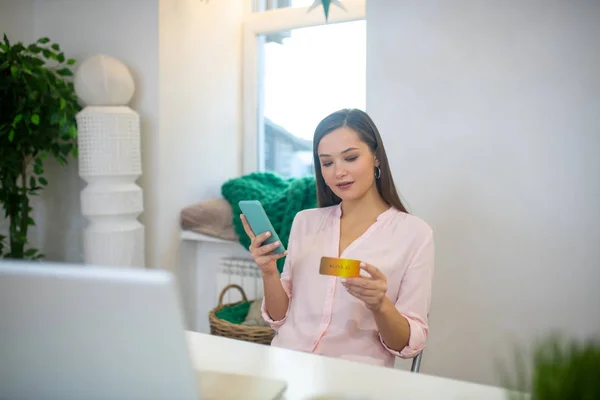 Pleasant young woman making a payment online — Stock Photo, Image